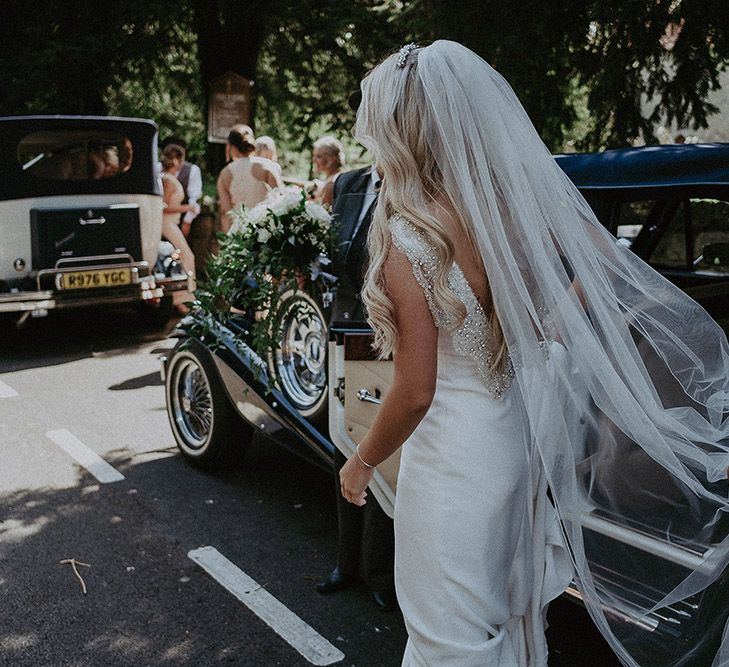 Bridal Entrance in Vintage Wedding Car Wearing St Patrick Wedding Dress and Wedding Veil