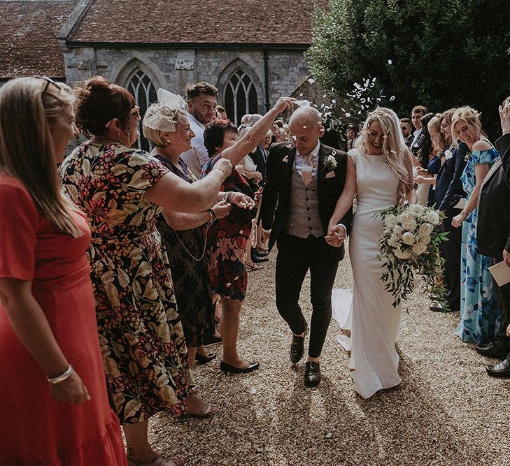 Confetti Moment with Bride in St Patrick Wedding Dress and Groom in Dark Suit