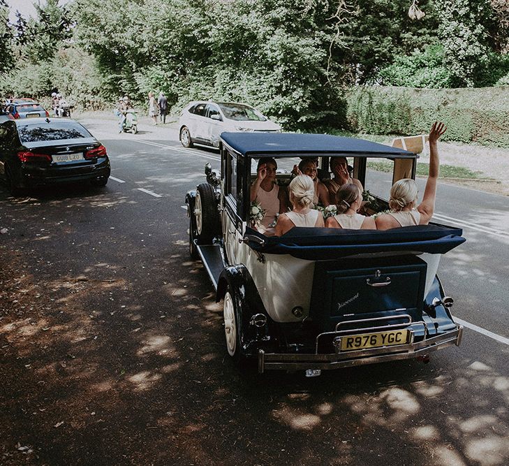 Bridal Party Sitting in Vintage Wedding Car