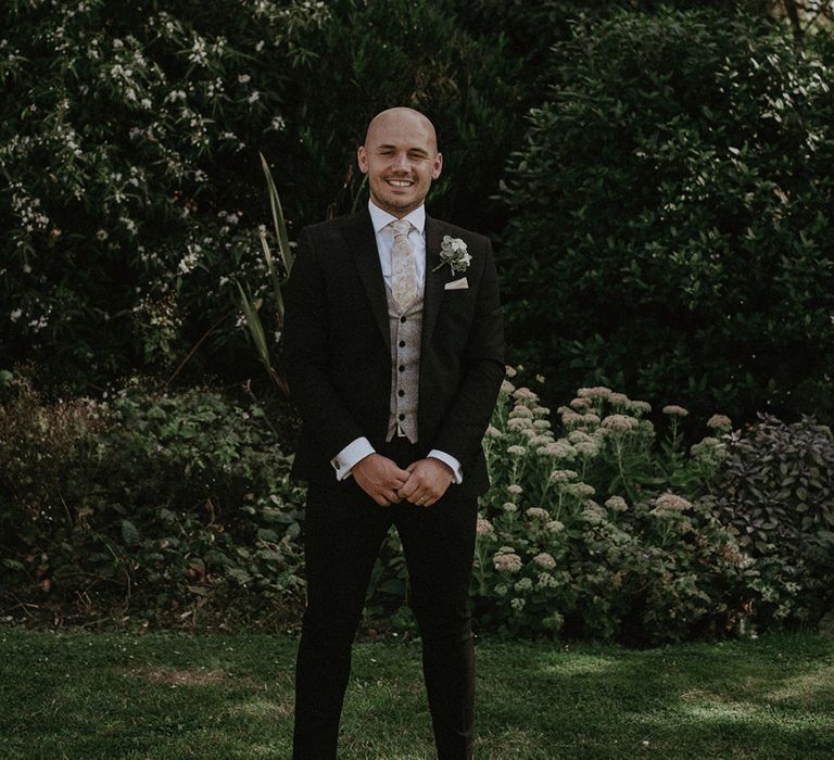 Groom in Dark Suit with Printed Waistcoat and Loafers