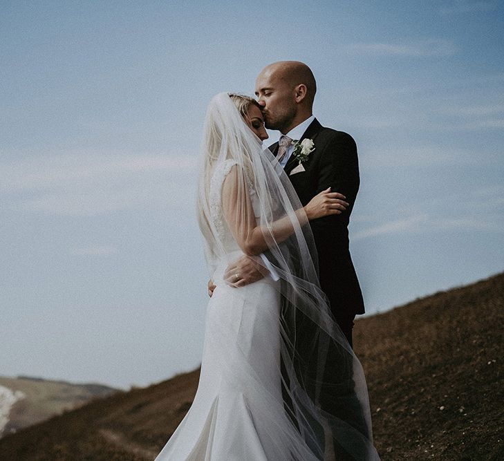 Isle of Wight Coastal Portrait of Bride in St Patrick Wedding Dress and Wedding Veil with Groom in Dark Suit