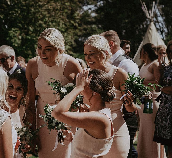 Bride and Bridesmaids Laughing During Drinks Reception