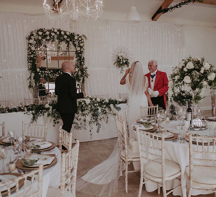 Bride and Groom Standing in Marquee Reception with Toast Master