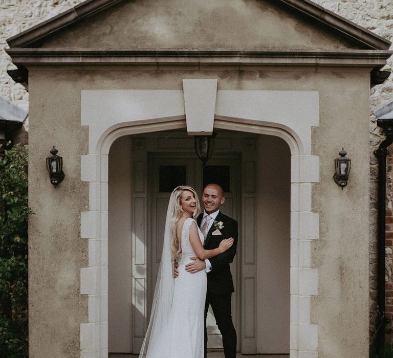 Bride in St Patrick Wedding Dress and Groom in Dark Suit