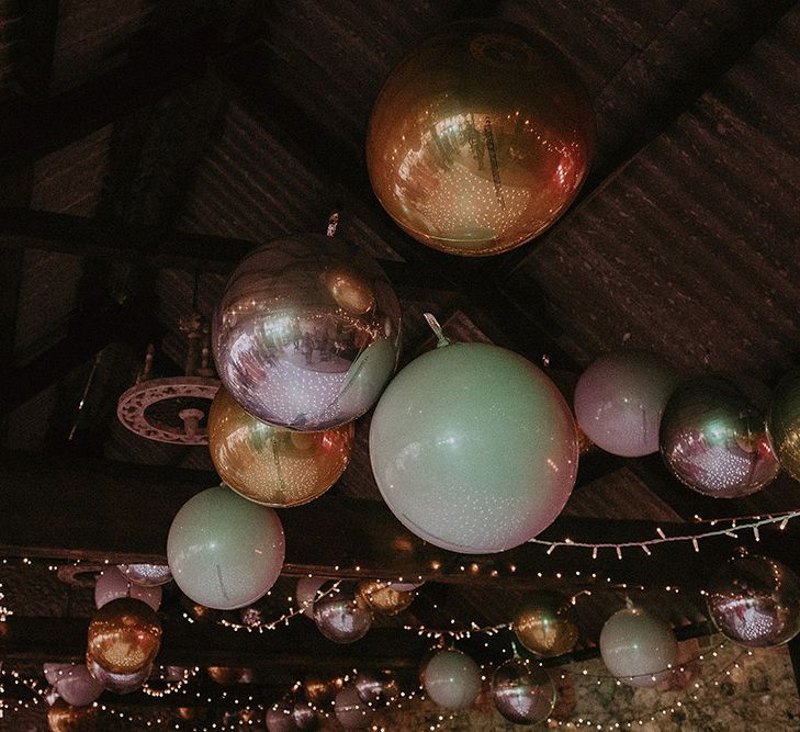 Fairy Lights and Metallic Balls Decorating The Ceiling