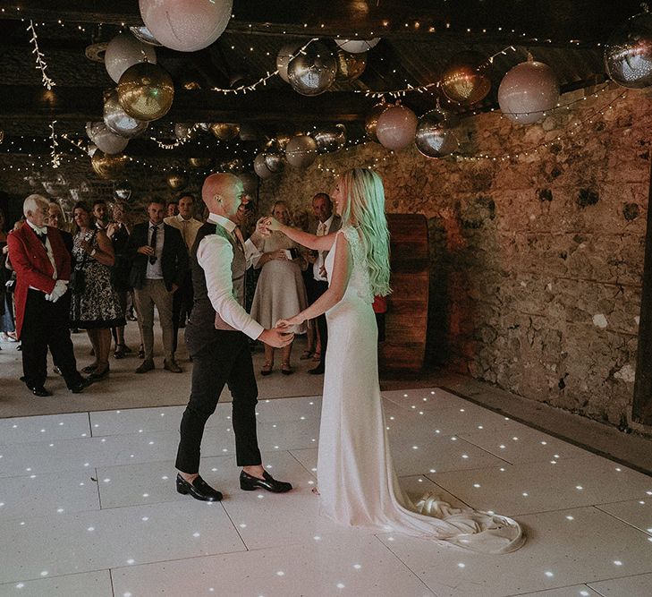 Bride and Groom First Dance with Fairy Lights and Balloons Decorating The Ceiling