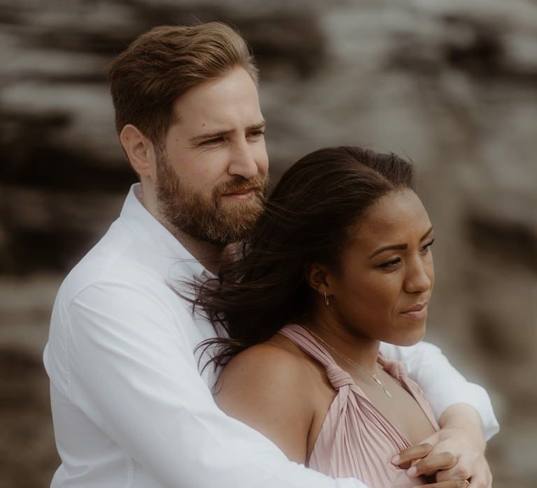 Groom-to-be in white shirt embracing his bride-to-be