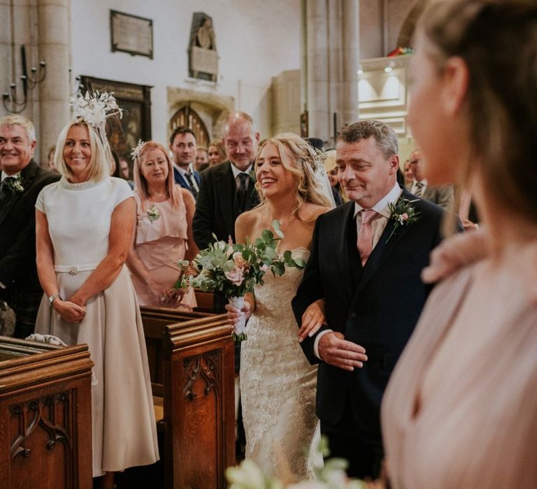 Bride walks up the aisle in Enzoani wedding dress