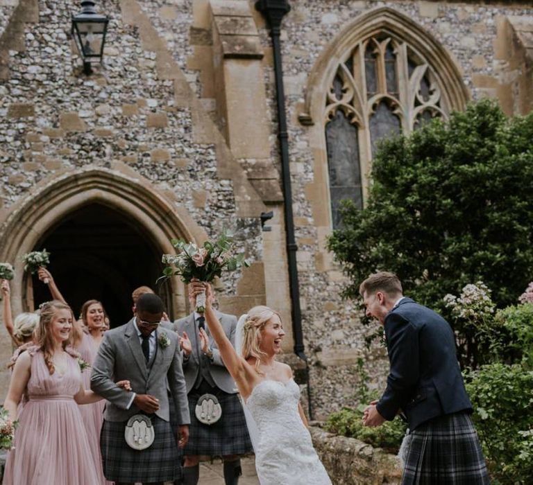 Bride and groom celebrate their wedding with bride in Enzoani wedding dress