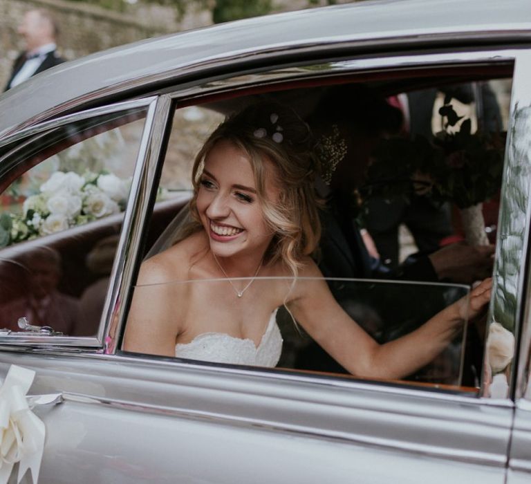 Bride in vintage wedding car