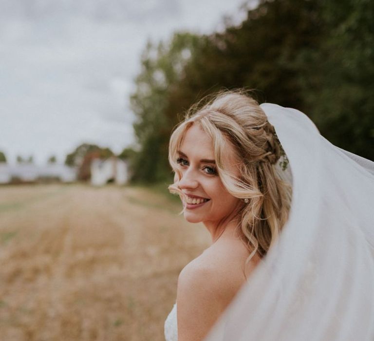 Bride with hair half up half down style and veil