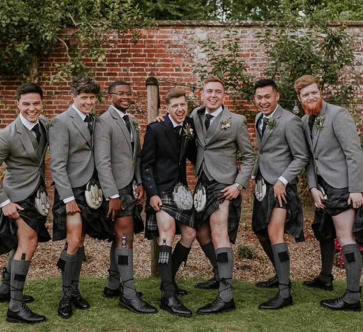 Groom and groomsmen pose in their kilts