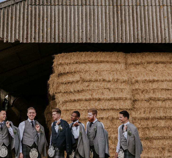 Groom and groomsmen in kilts for wedding