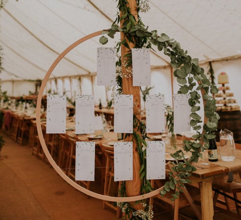 Hoop wedding table plan at marquee wedding