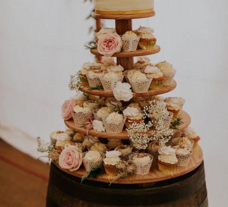 Wedding cake and cupcakes with flower decoration