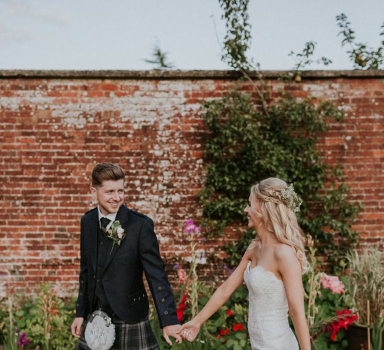 Groom and bride in Enzoani wedding dress take a moment