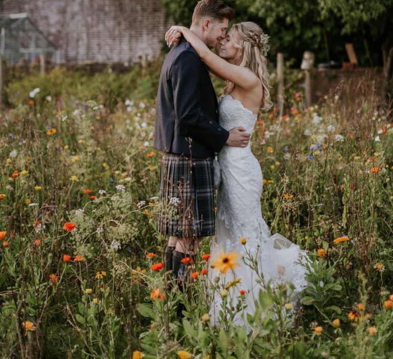 Bride in strapless Enzoani wedding dress and groom in kilt