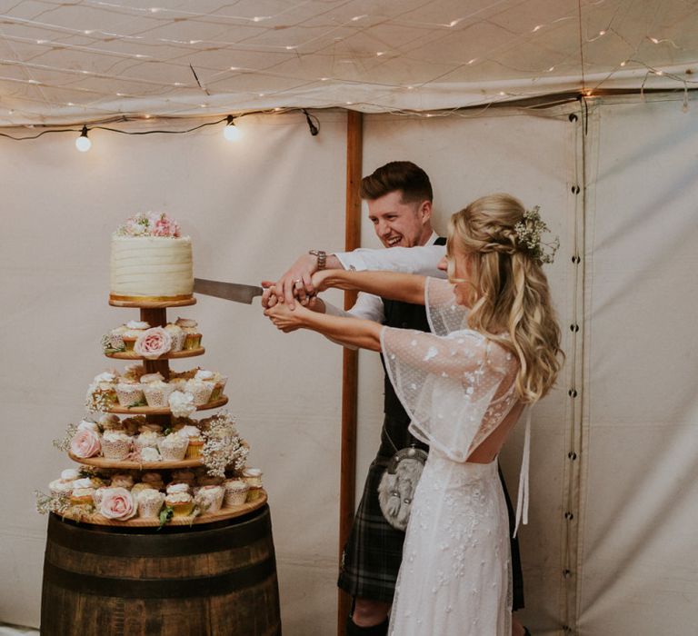 Bride and groom cut wedding cake