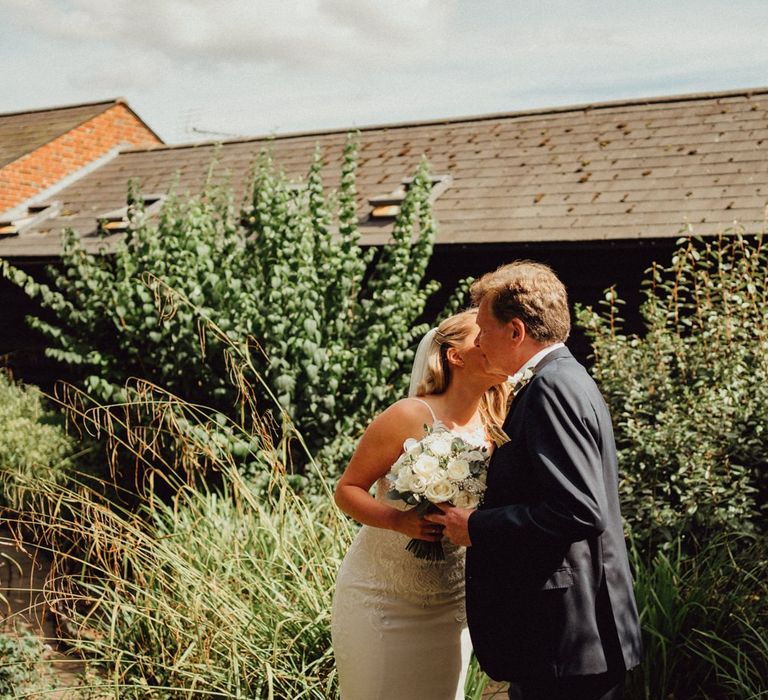 Bride kisses father at Altar before greeting wife-to-be