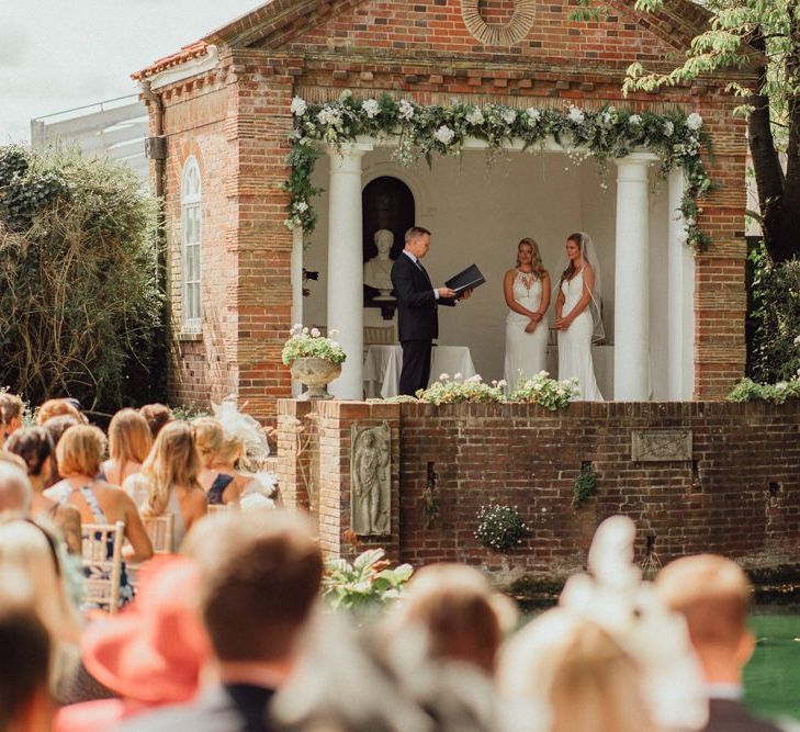 Beautiful outdoor wedding ceremony next to pond at Micklefield Hall wedding