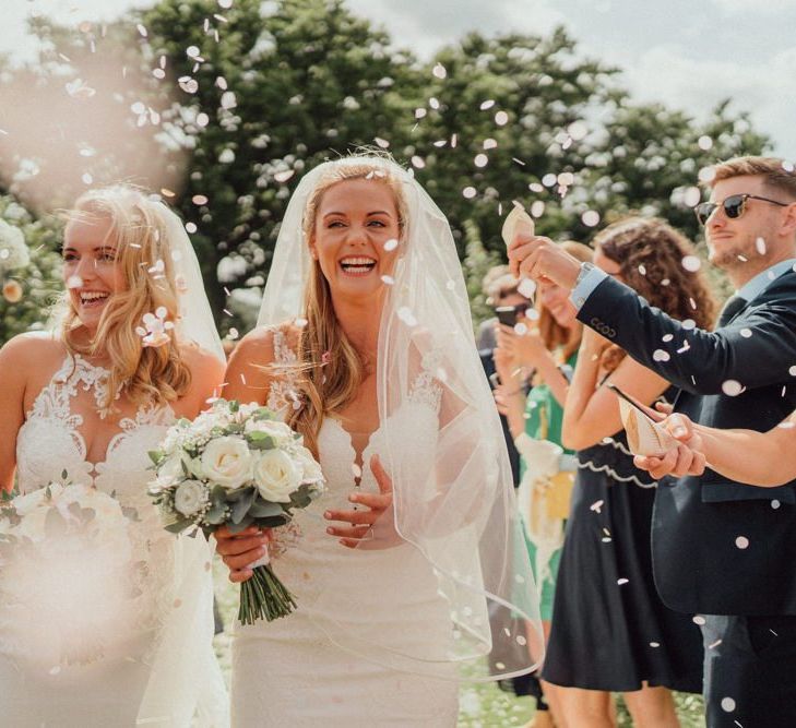 Confetti exit for bride and bride at Micklefield Hall wedding