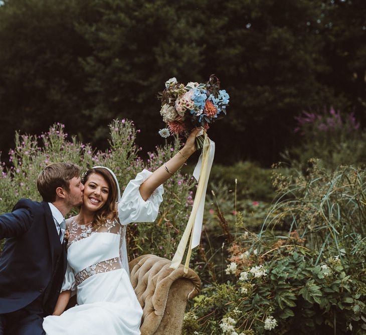 Bride in Rime Arodaky Wedding Dress and Groom is Reiss Suit at Outdoor Wedding Ceremony