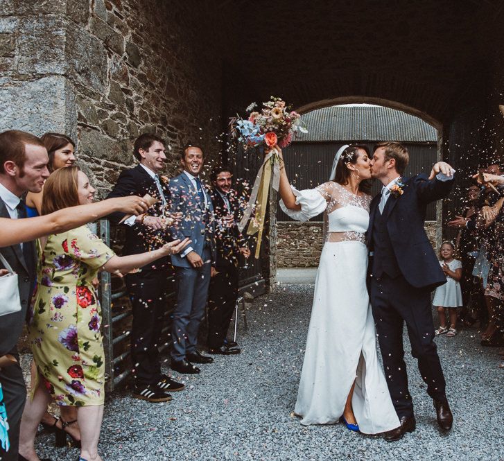 Confetti Moment with Bride in Rime Arodaky Wedding Dress and Groom is Reiss Suit