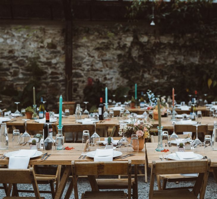 Wedding Reception Table Decor with Pastel Pink and Blue Taper Candles and Potted Plants