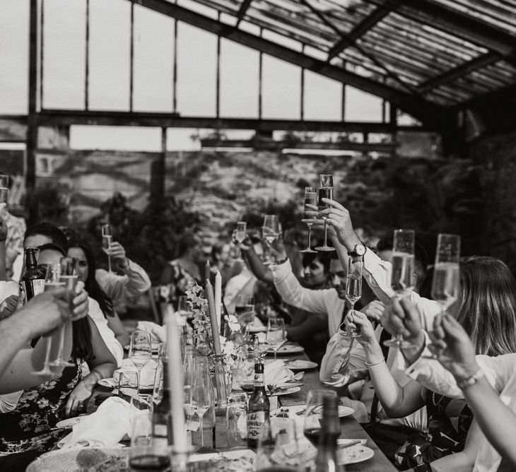 Wedding Guests Raising Their Glass at The Wedding Reception