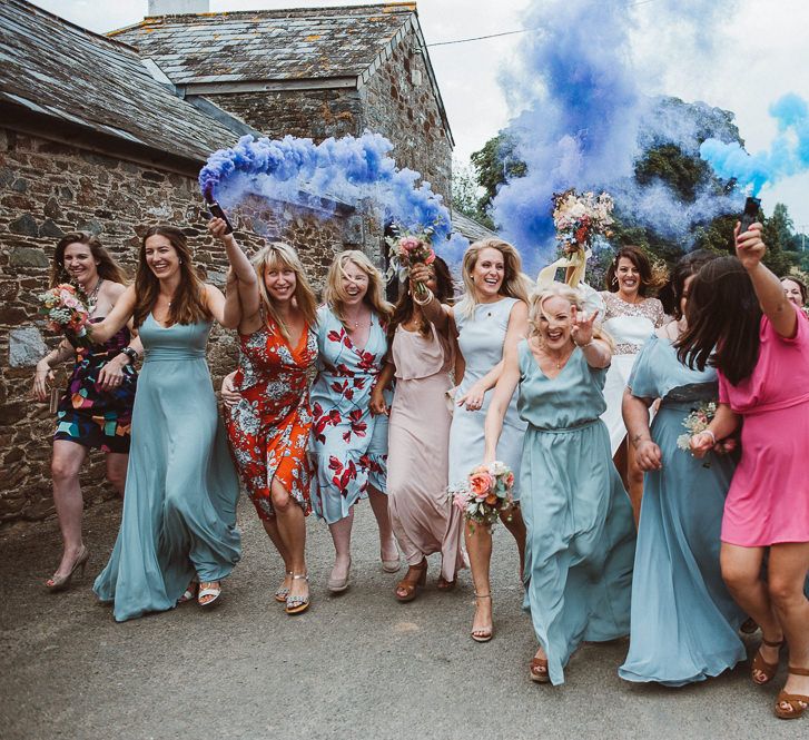 Bride and Best Girls Walking Down the Street Holding Smoke Bombs