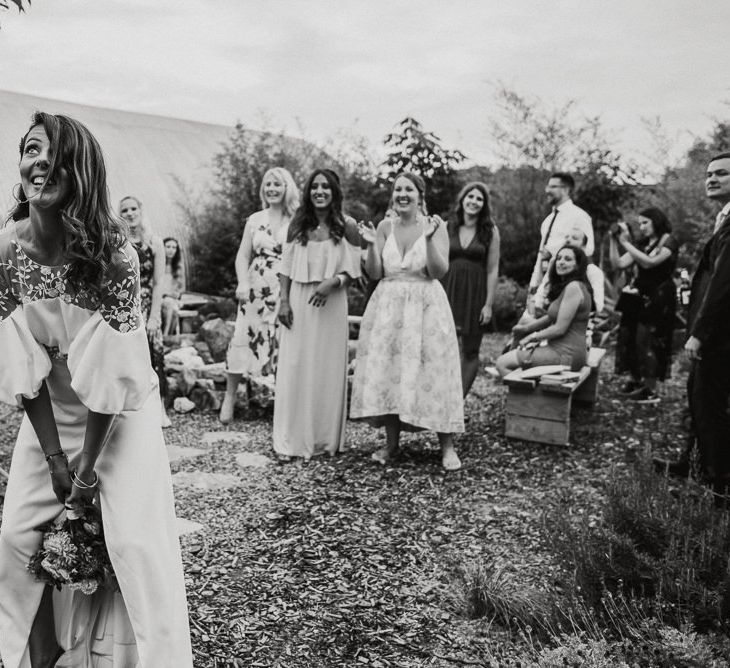 Bride in Rime Arodaky Wedding Dress Tossing Her Wedding Bouquet