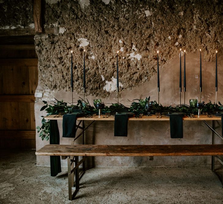 Black Taper Candles &amp; Greenery Garland Wedding Table Decor | Forest Green and Black Dark Decadence Wedding Inspiration in a Rustic Barn Planned &amp; Styled by Knots &amp; Kisses with Images by Daze of Glory Photography