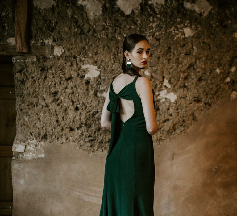 Bridesmaid in Tie Back Forest Green Dress | Forest Green and Black Dark Decadence Wedding Inspiration in a Rustic Barn Planned &amp; Styled by Knots &amp; Kisses with Images by Daze of Glory Photography