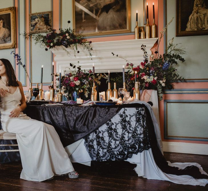 Bride in River Elliot Bridal Gown | Tablescape with Candlesticks  | Dark Opulence Inspiration at Anstey Hall, Cambridgeshire Styled by Mia Sylvia | Camilla Andrea Photography