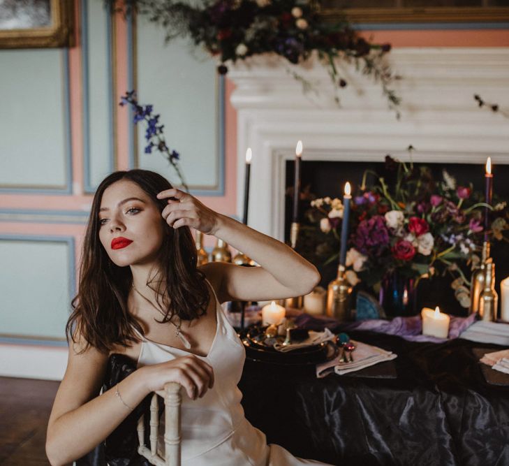 Bride in River Elliot Bridal Gown | Tablescape with Candlesticks  | Dark Opulence Inspiration at Anstey Hall, Cambridgeshire Styled by Mia Sylvia | Camilla Andrea Photography