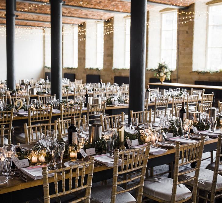 Industrial Wedding Reception with String Lights and Greenery Garland Centrepiece