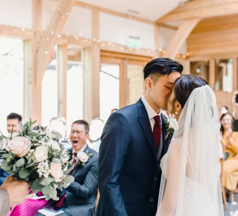 Bride and grooms first kiss