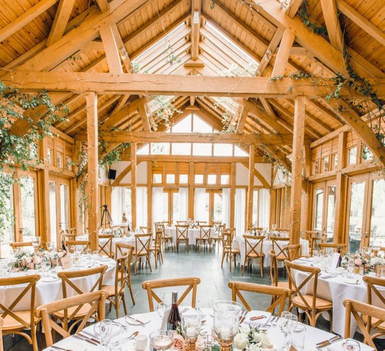 Rustic styled wedding reception with rose gold centrepiece decor and dusky pink roses