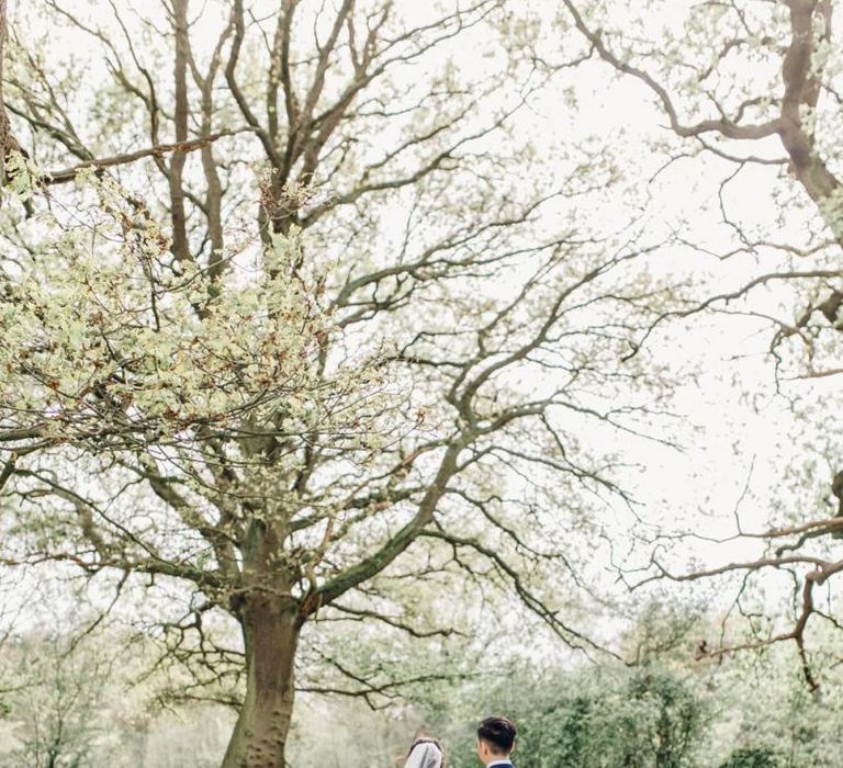 Back of brides lace dress with long veil