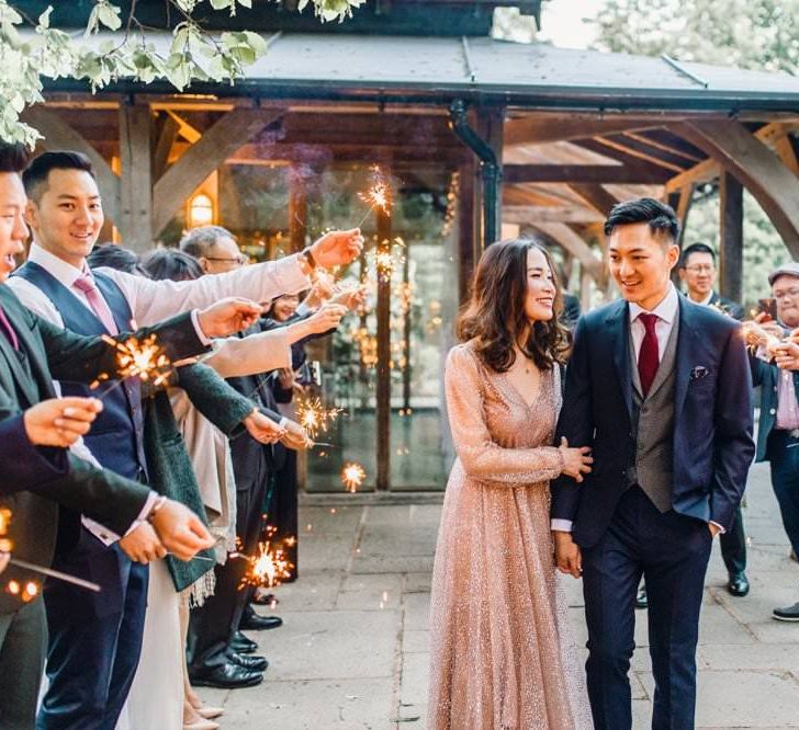 Sparkler exit with bride wearing a beautiful gold glitter evening gown