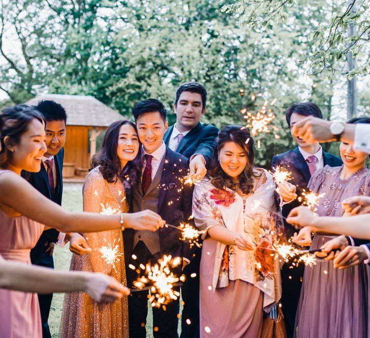 Sparkler exit with bride wearing a beautiful gold glitter evening gown