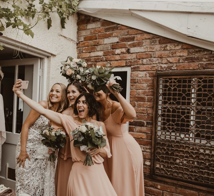 Bride in Sasha Dress by Made With Love with Crochet Finish, Fishtail Train, V-Neck and Plunging Back | Bridesmaids in Mismatched Peach Rewritten Dresses, Tops and Skirts | Wedding Bouquets of Blush and White Roses, Gypsophila and Eucalyptus | Yurt Wedding with Outdoor Naked Tipi Ceremony, Glitter Station &amp; Peach Rewritten Bridesmaid Dresses | Nesta Lloyd Photography