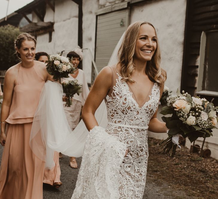 Bride in Sasha Dress by Made With Love with Crochet Finish, Fishtail Train, V-Neck and Plunging Back | Bridesmaids in Mismatched Peach Rewritten Dresses, Tops and Skirts | Wedding Bouquets of Blush and White Roses, Gypsophila and Eucalyptus | Yurt Wedding with Outdoor Naked Tipi Ceremony, Glitter Station &amp; Peach Rewritten Bridesmaid Dresses | Nesta Lloyd Photography