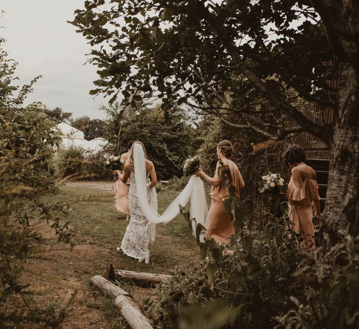 Bride in Sasha Dress by Made With Love with Crochet Finish, Fishtail Train, V-Neck and Plunging Back | Bridesmaids in Mismatched Peach Rewritten Dresses, Tops and Skirts | Wedding Bouquets of Blush and White Roses, Gypsophila and Eucalyptus | Yurt Wedding with Outdoor Naked Tipi Ceremony, Glitter Station &amp; Peach Rewritten Bridesmaid Dresses | Nesta Lloyd Photography