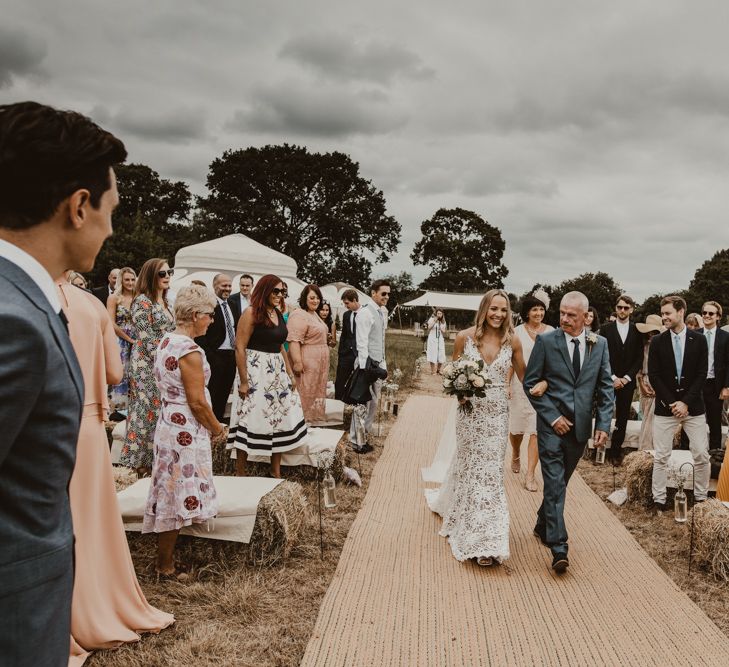 Bride in Sasha Dress by Made With Love with Crochet Finish, Fishtail Train, V-Neck and Plunging Back | Bridal Bouquet of Blush and White Roses, Gypsophila and Eucalyptus | Hessian Aisle | Hay Bales with White Blankets | Outdoor Wedding Ceremony at Sychpwll Centre Wales | Yurt Wedding with Outdoor Naked Tipi Ceremony, Glitter Station &amp; Peach Rewritten Bridesmaid Dresses | Nesta Lloyd Photography