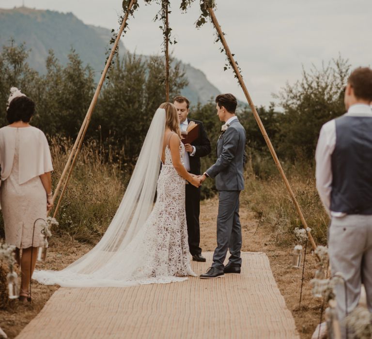 Bride in Sasha Dress by Made With Love with Crochet Finish, Fishtail Train, V-Neck and Plunging Back | Groom in Light Blue Two-Piece Suit by Hugo Boss | Blush Pink Buttonhole | Yurt Wedding with Outdoor Naked Tipi Ceremony, Glitter Station &amp; Peach Rewritten Bridesmaid Dresses | Nesta Lloyd Photography