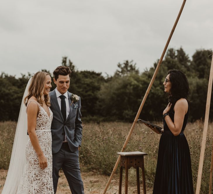 Bride in Sasha Dress by Made With Love with Crochet Finish, Fishtail Train, V-Neck and Plunging Back | Groom in Light Blue Two-Piece Suit by Hugo Boss | Blush Pink Buttonhole | Yurt Wedding with Outdoor Naked Tipi Ceremony, Glitter Station &amp; Peach Rewritten Bridesmaid Dresses | Nesta Lloyd Photography