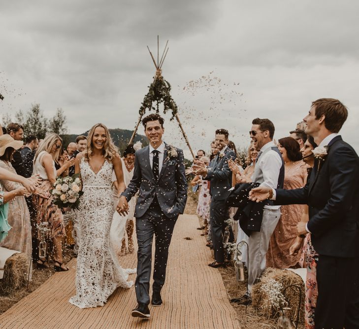 Bride in Sasha Dress by Made With Love with Crochet Finish, Fishtail Train, V-Neck and Plunging Back | Bridal Bouquet of Blush and White Roses, Gypsophila and Eucalyptus | Groom in Light Blue Two-Piece Suit by Hugo Boss | Blush Pink Buttonhole | Hessian Aisle | Hay Bales with White Blankets | Yurt Wedding with Outdoor Naked Tipi Ceremony, Glitter Station &amp; Peach Rewritten Bridesmaid Dresses | Nesta Lloyd Photography