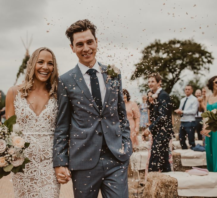 Bride in Sasha Dress by Made With Love with Crochet Finish, Fishtail Train, V-Neck and Plunging Back | Bridal Bouquet of Blush and White Roses, Gypsophila and Eucalyptus | Groom in Light Blue Two-Piece Suit by Hugo Boss | Blush Pink Buttonhole | Hessian Aisle | Hay Bales with White Blankets | Yurt Wedding with Outdoor Naked Tipi Ceremony, Glitter Station &amp; Peach Rewritten Bridesmaid Dresses | Nesta Lloyd Photography