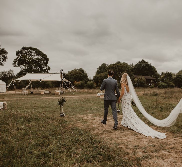 Bride in Sasha Dress by Made With Love with Crochet Finish, Fishtail Train, V-Neck and Plunging Back | Groom in Light Blue Two-Piece Suit by Hugo Boss | Yurt Wedding with Outdoor Naked Tipi Ceremony, Glitter Station &amp; Peach Rewritten Bridesmaid Dresses | Nesta Lloyd Photography